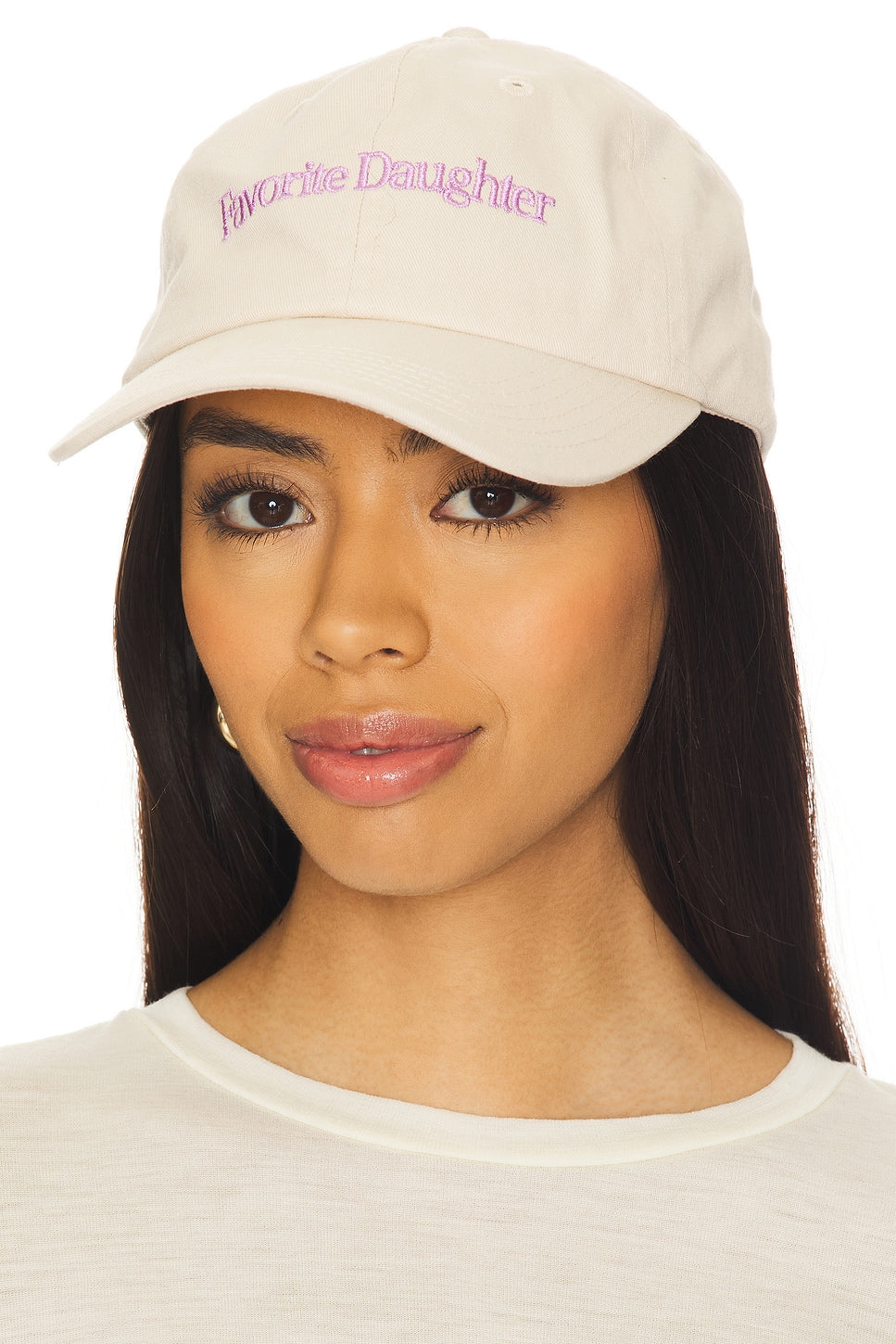 Woman wearing a beige cap with 'Favorite Daughter' text on a white background