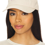 Woman wearing a beige cap with 'Favorite Daughter' text on a white background