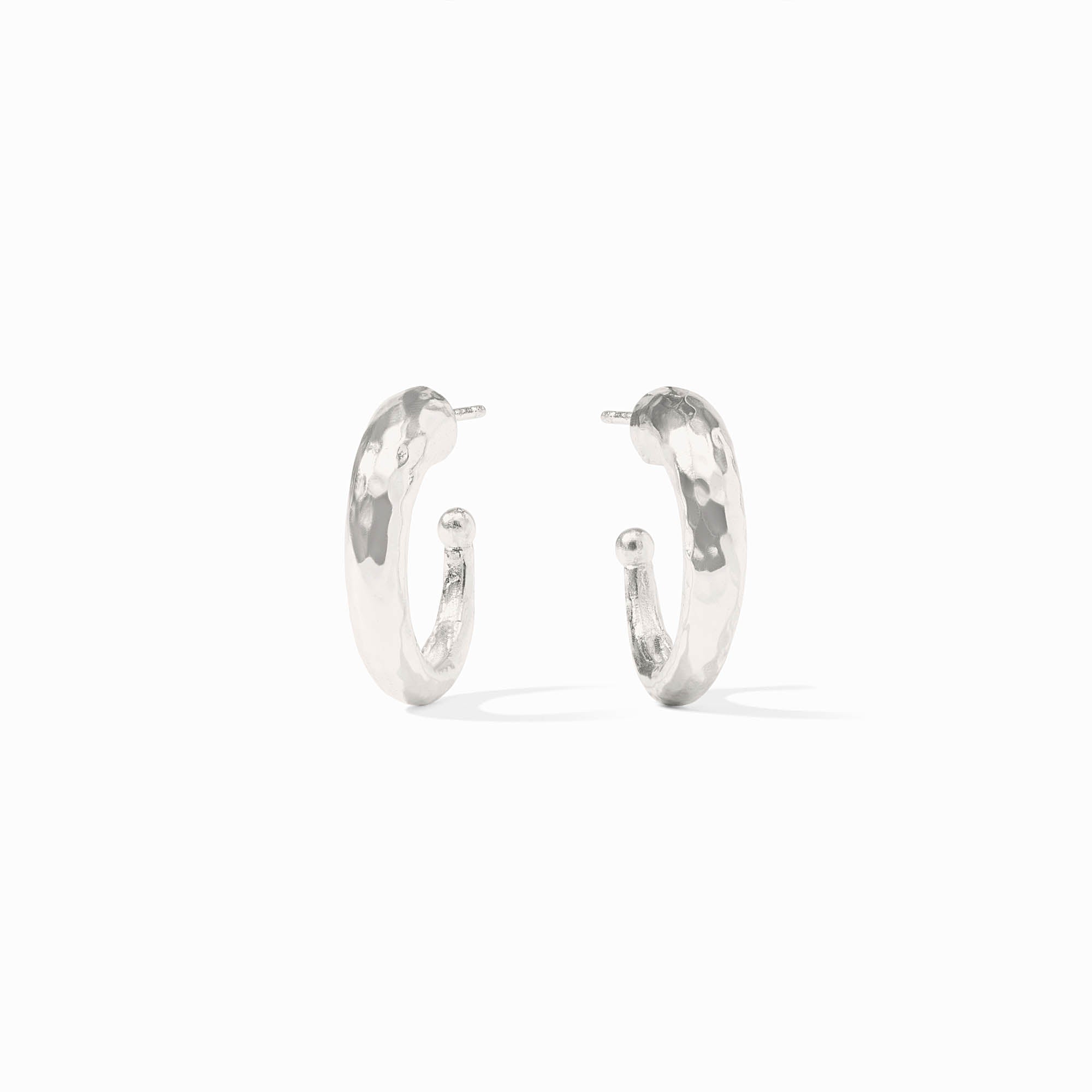 Pair of silver hoop earrings on a white background