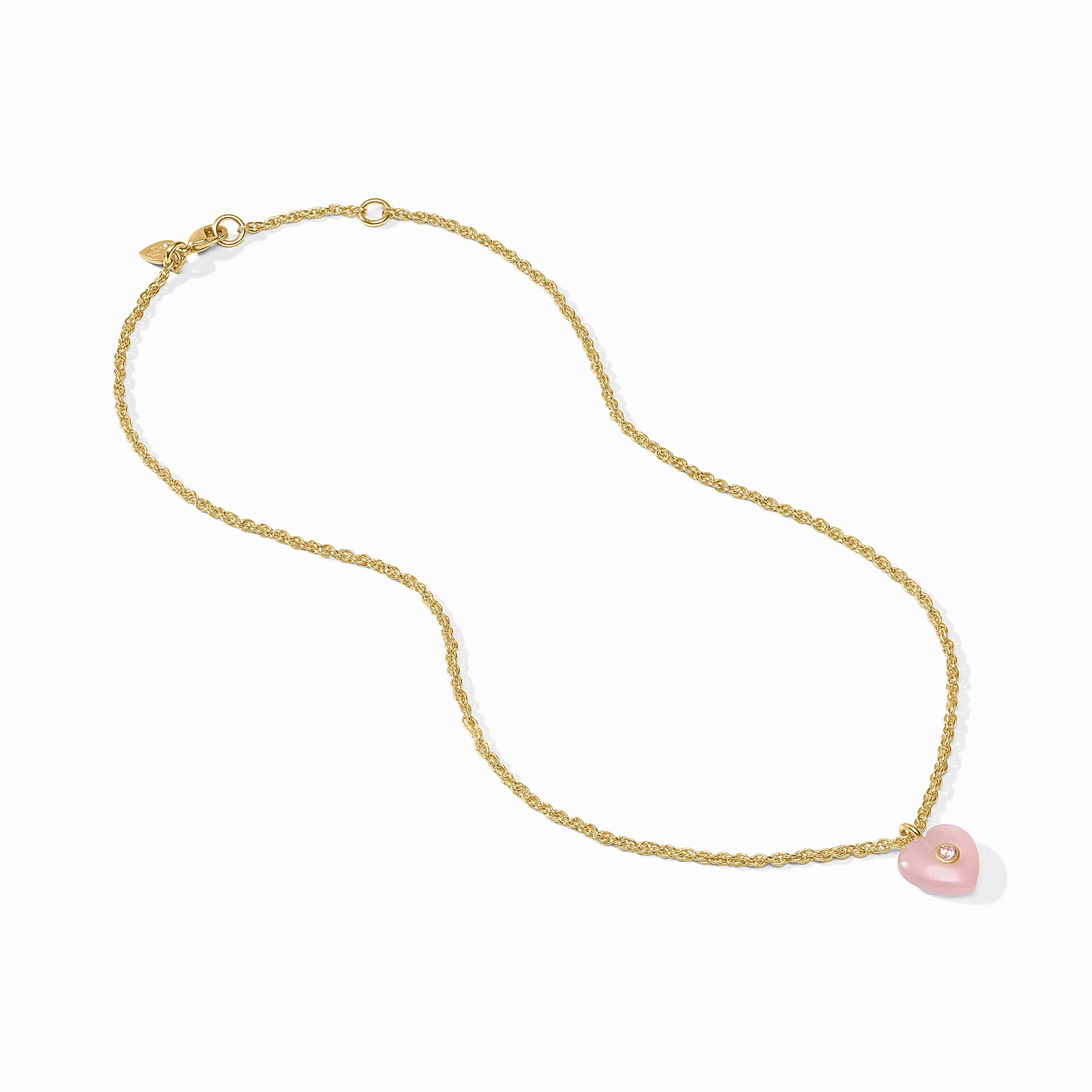 Gold chain necklace with a pink pendant on a white background