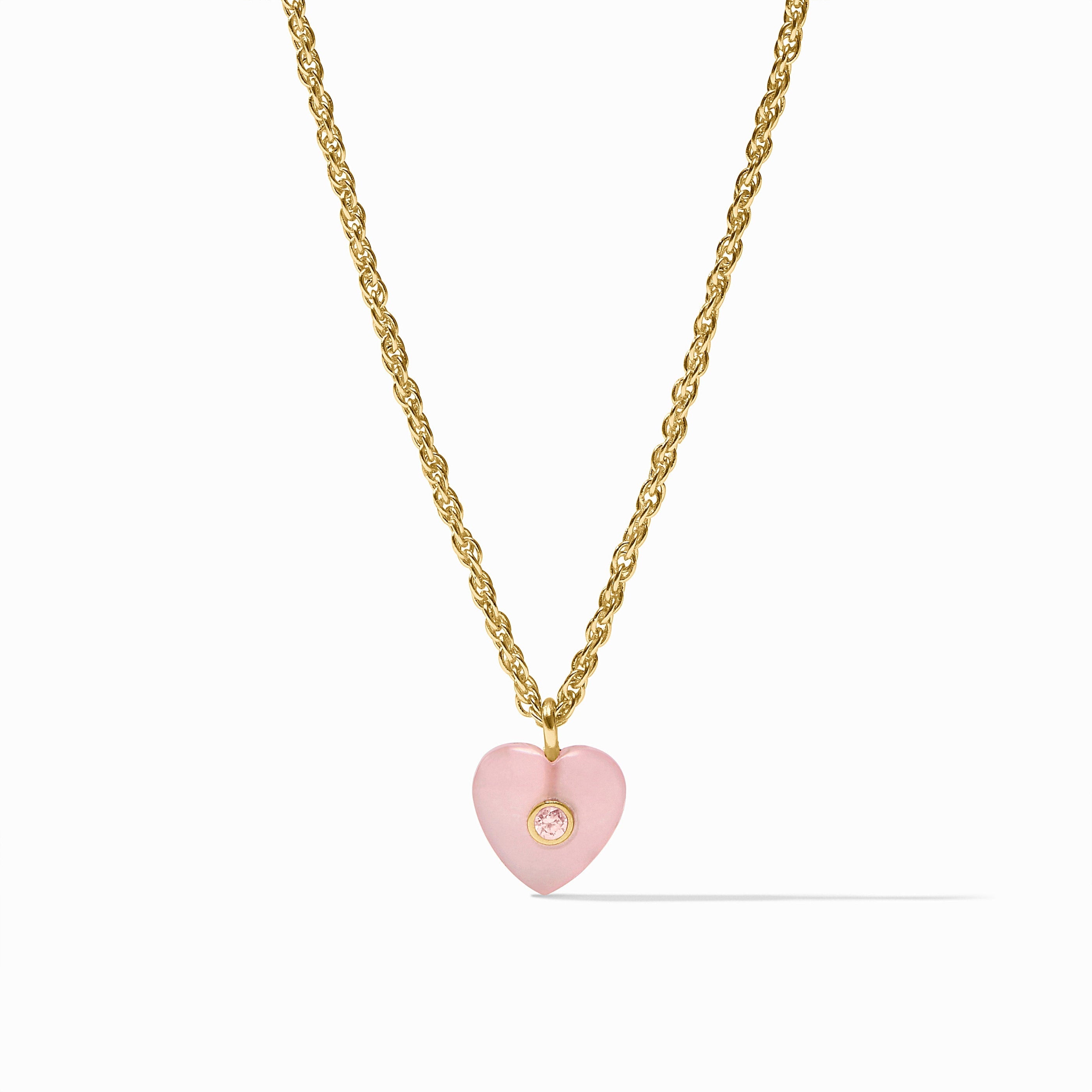 Necklace with a pink heart pendant and gold chain on a white background