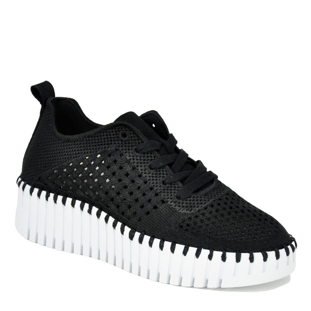 Black sneaker with white sole on a white background