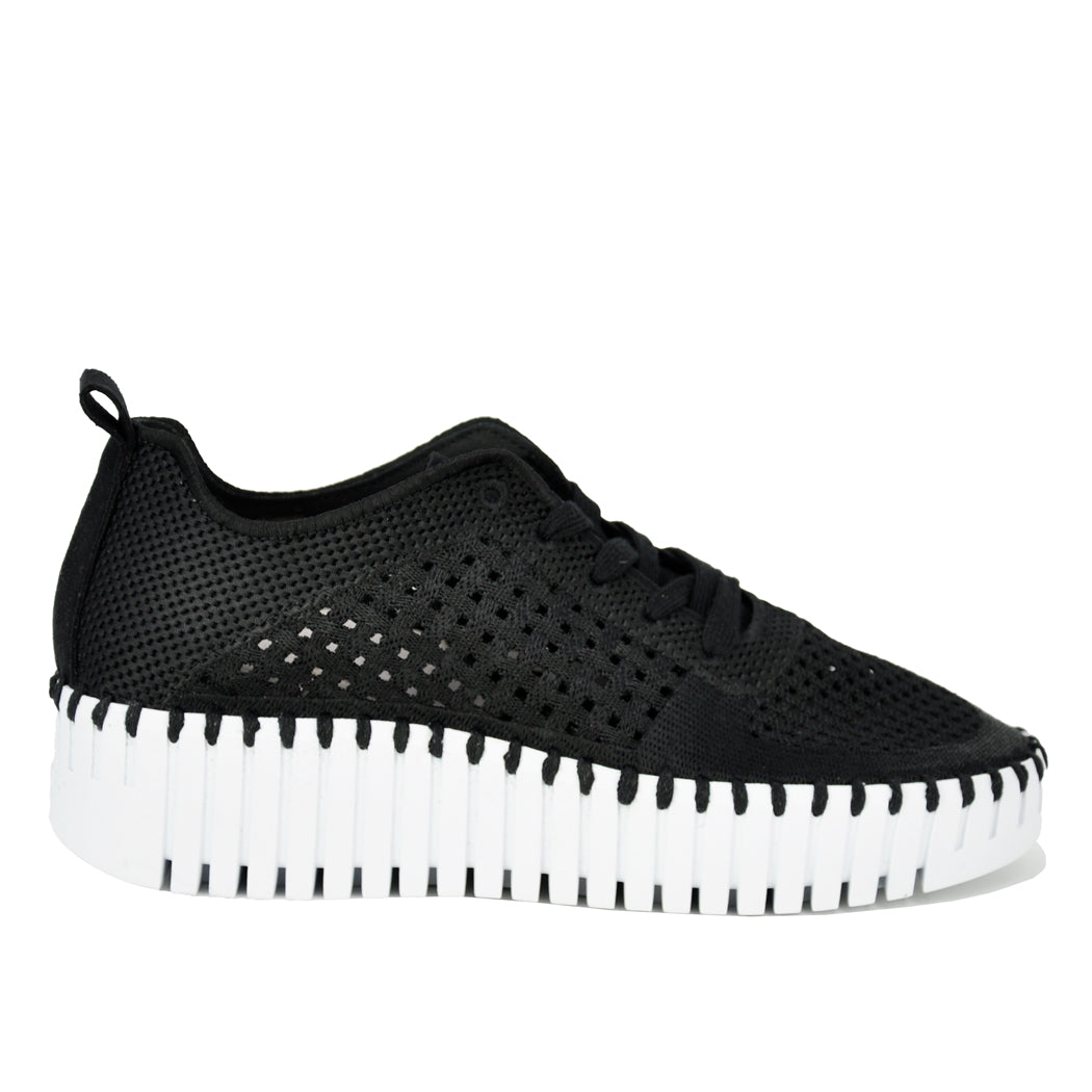 Black sneaker with white sole on a white background