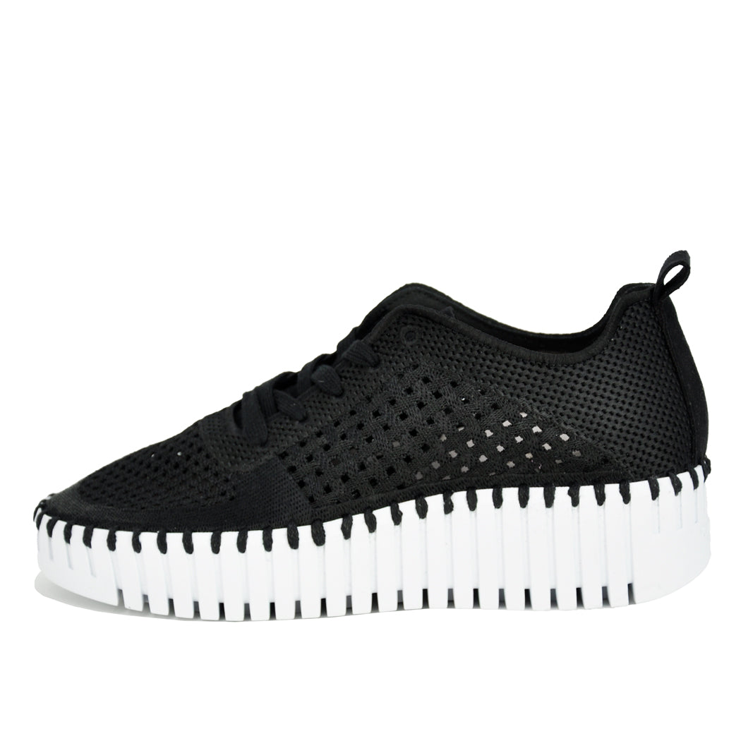 Black sneaker with a white sole on a white background