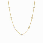 Gold necklace with small diamonds on a white background