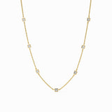 Gold necklace with small diamonds on a white background