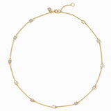 Gold necklace with small diamonds on a white background