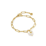 Gold chain bracelet with a heart-shaped pearl charm on a white background