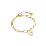 Gold chain bracelet with a heart-shaped pearl charm on a white background