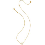 Gold necklace with a small pendant on a white background