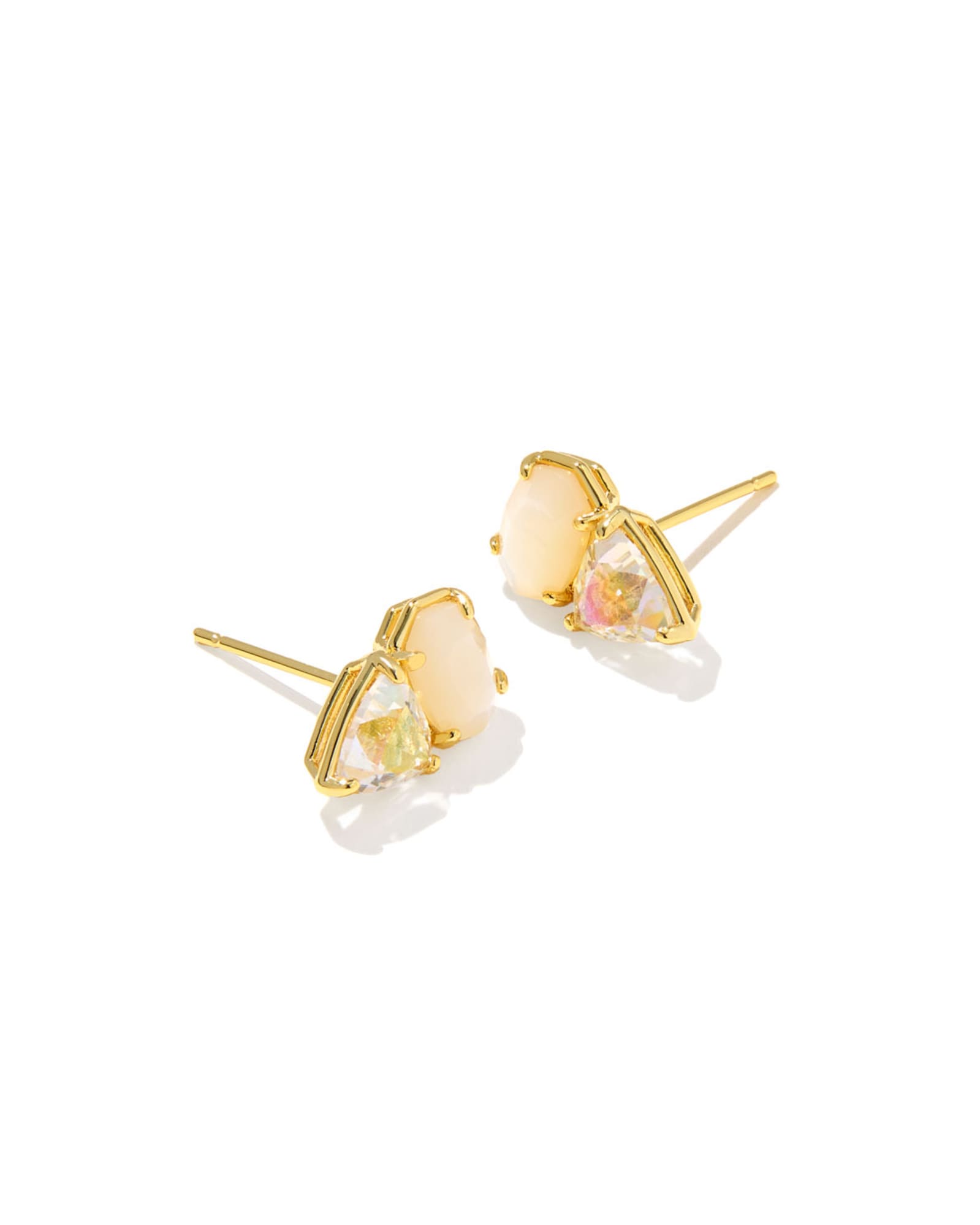 Gold earrings with clear gemstones on a white background