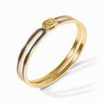 Gold bracelet with blue accents on a white background
