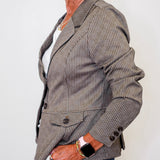 Person wearing a brown pinstripe blazer on a plain background