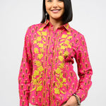 Woman wearing a pink floral shirt against a white background