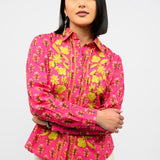 Woman wearing a pink floral blouse against a white background