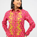Woman wearing a pink floral shirt against a white background