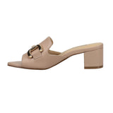 Beige sandal with a gold buckle on a white background