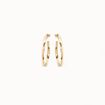 Gold hoop earrings on a white background
