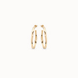 Gold hoop earrings on a white background
