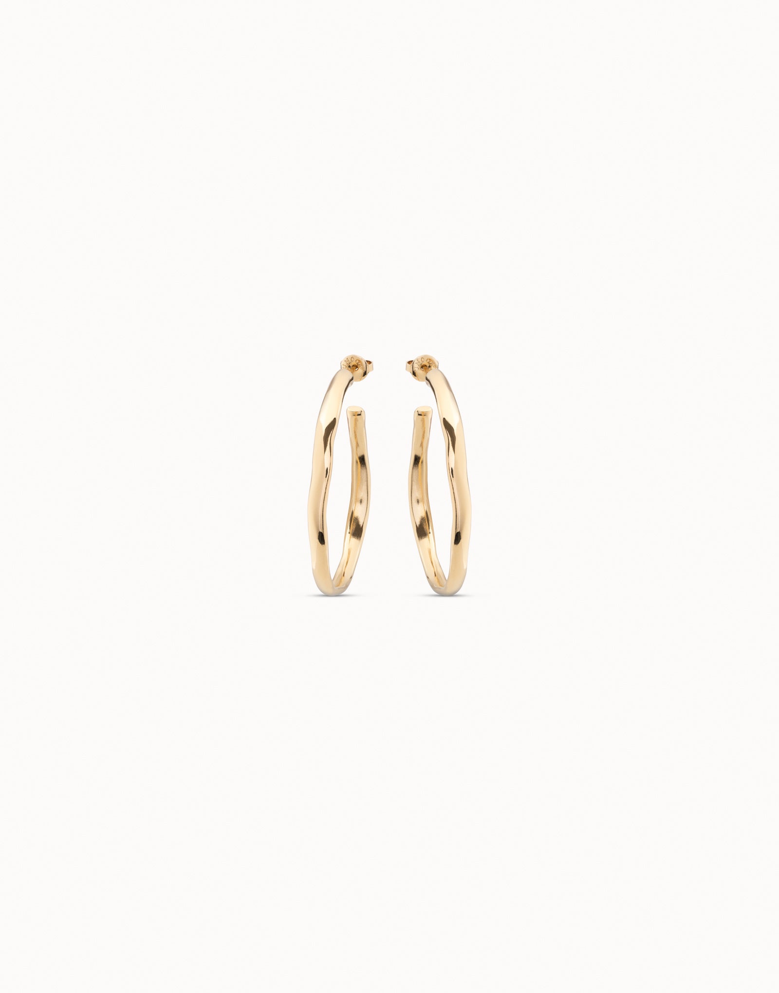 Gold hoop earrings on a white background