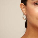 Silver hoop earrings on a white background
