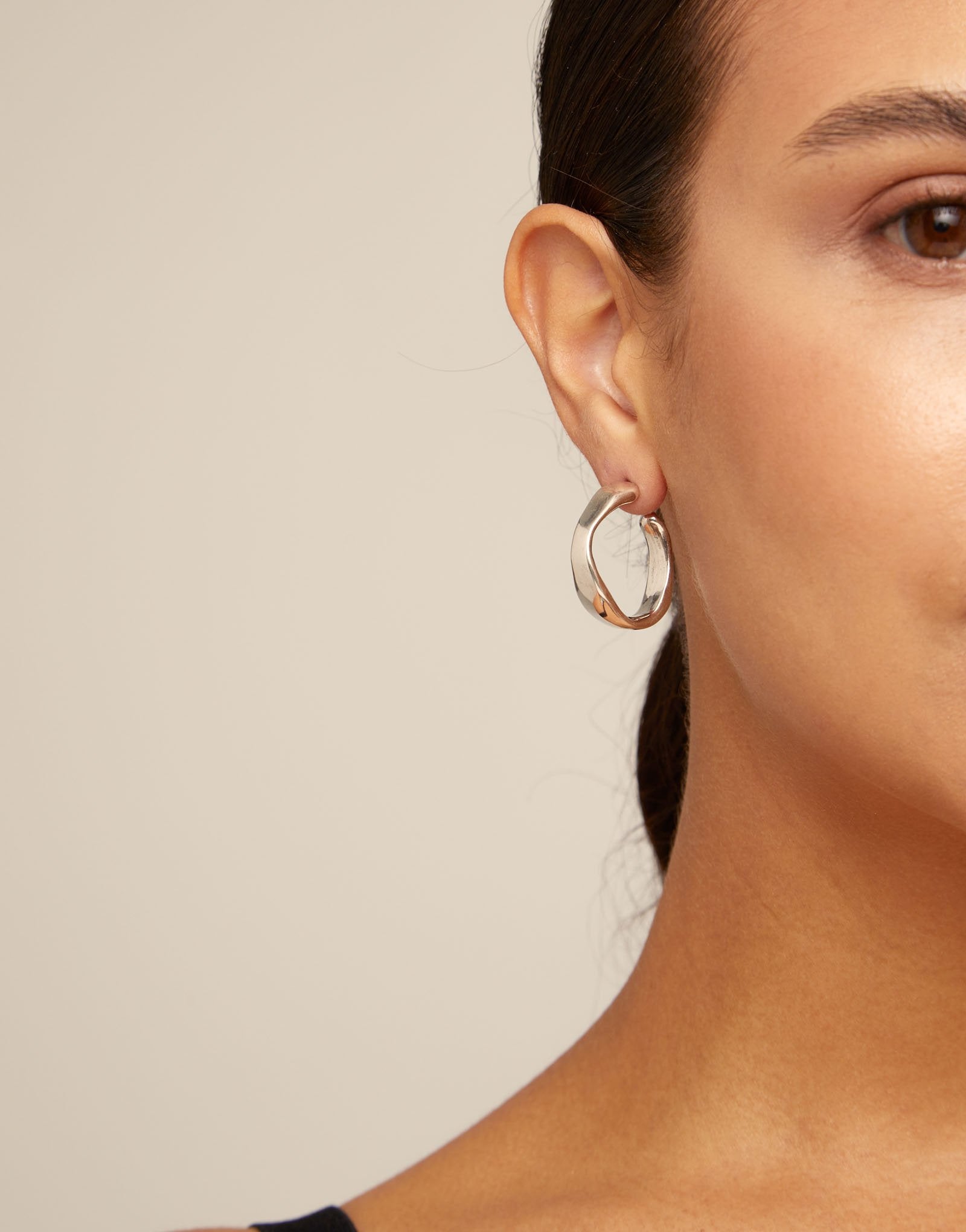 Silver hoop earrings on a white background