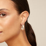 Silver hoop earrings on a white background