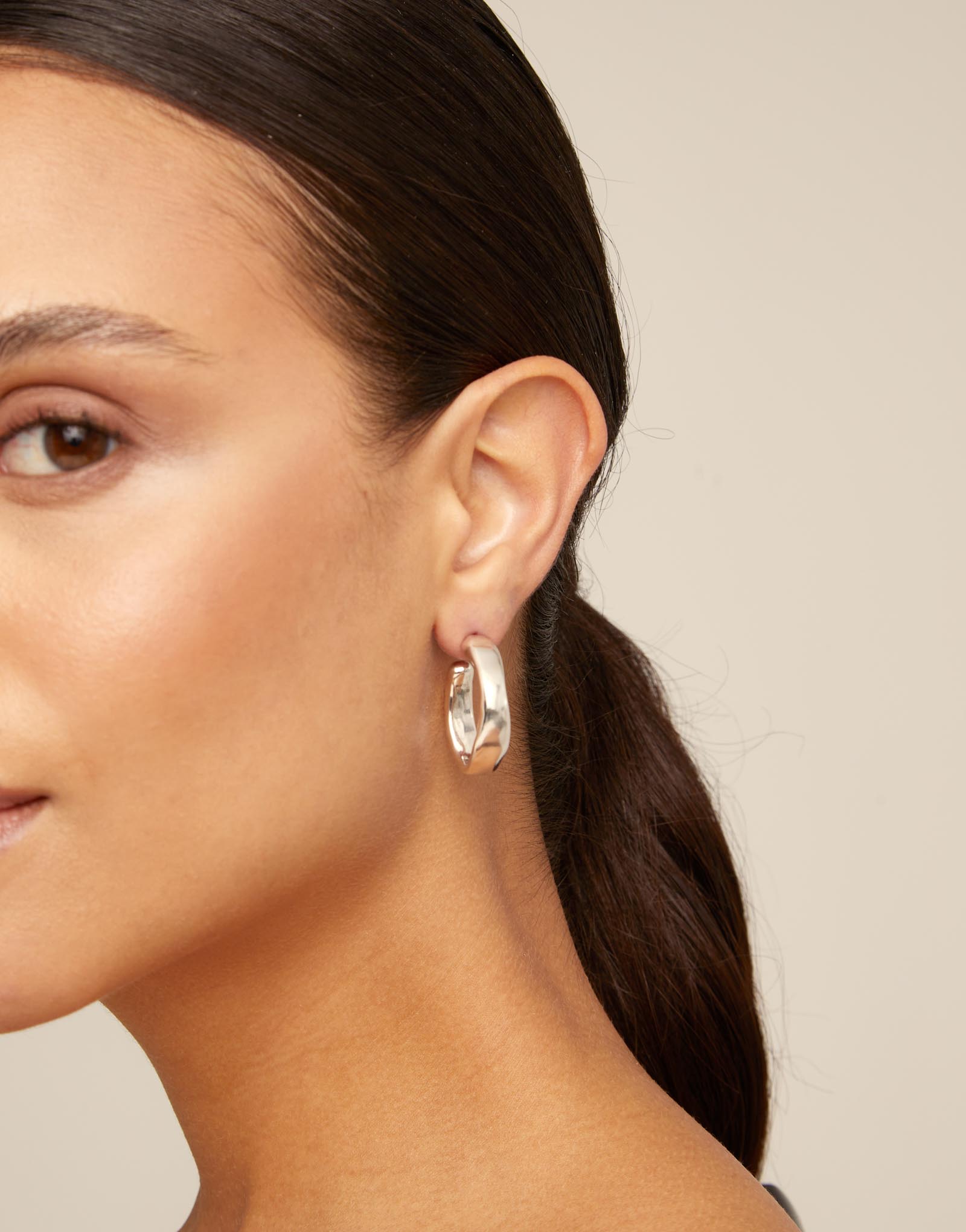 Silver hoop earrings on a white background