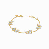 Gold bracelet with butterfly charms on a white background