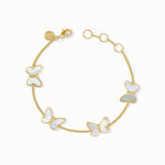 Gold bracelet with white butterfly charms on a white background