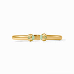 Gold bracelet with green gemstones on a white background