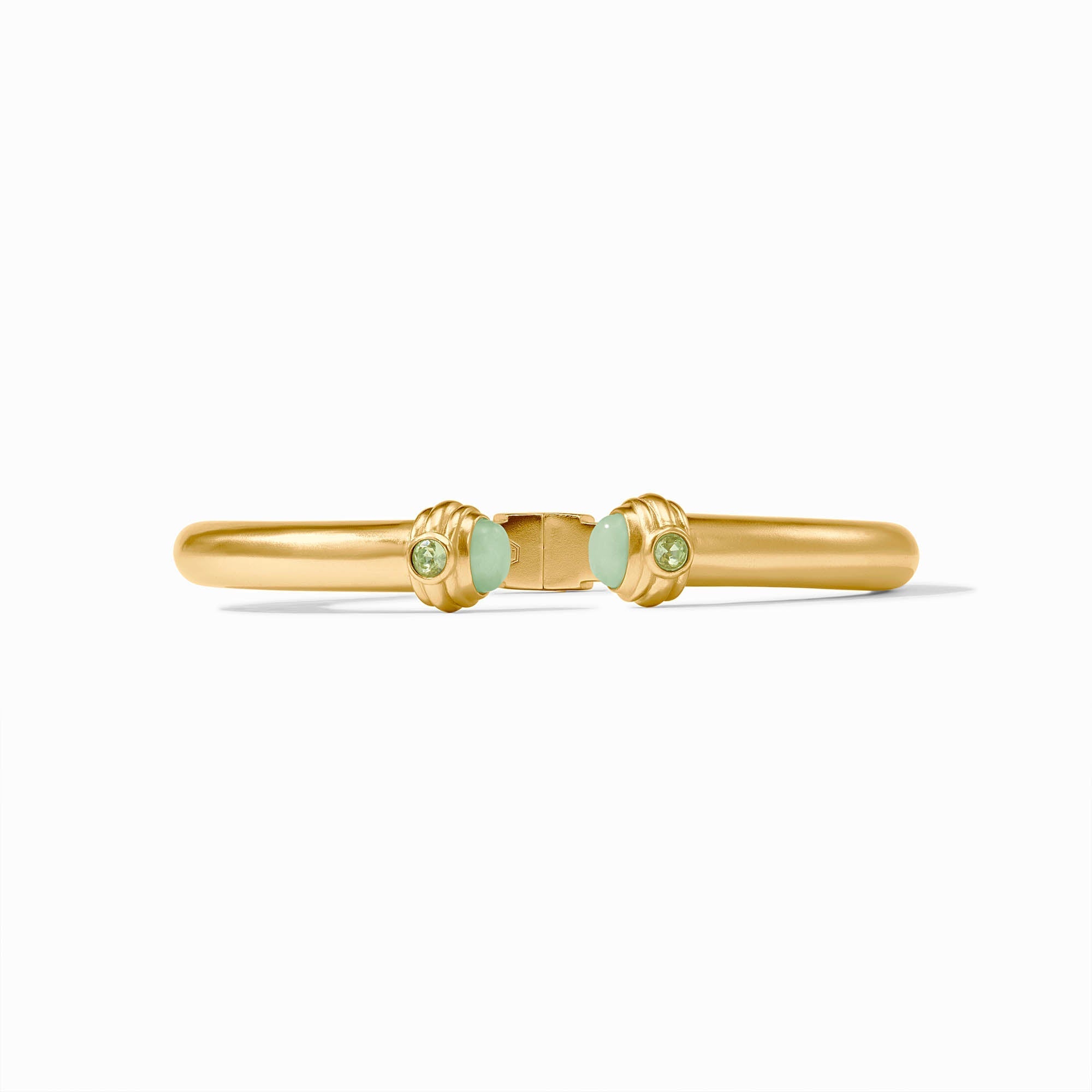 Gold bracelet with green gemstones on a white background