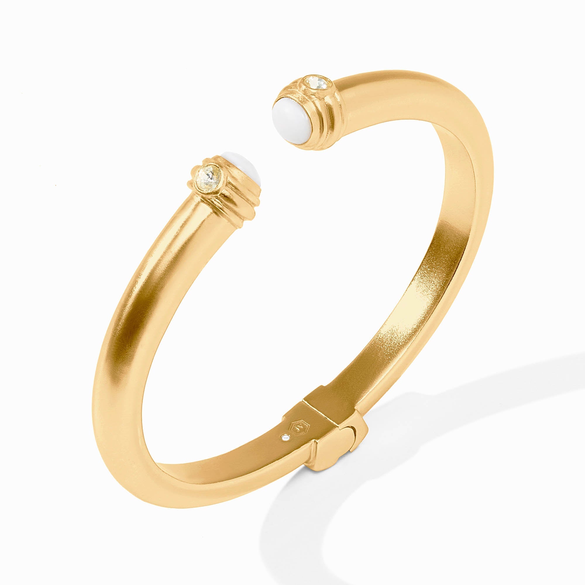 Gold bracelet with white stones on a white background