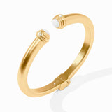 Gold bracelet with white stones on a white background