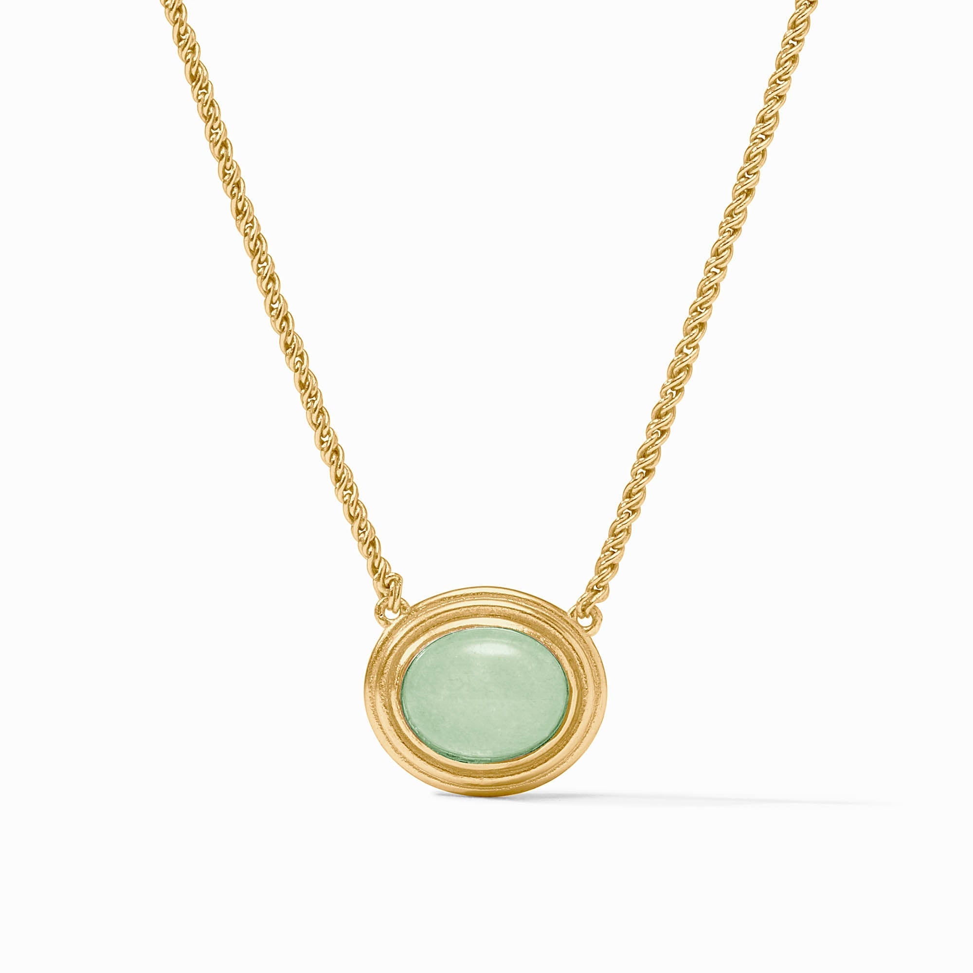 Gold necklace with a green pendant on a white background