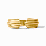 Gold bracelet with a ribbed design on a white background