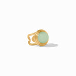 Gold ring with a light green gemstone on a white background
