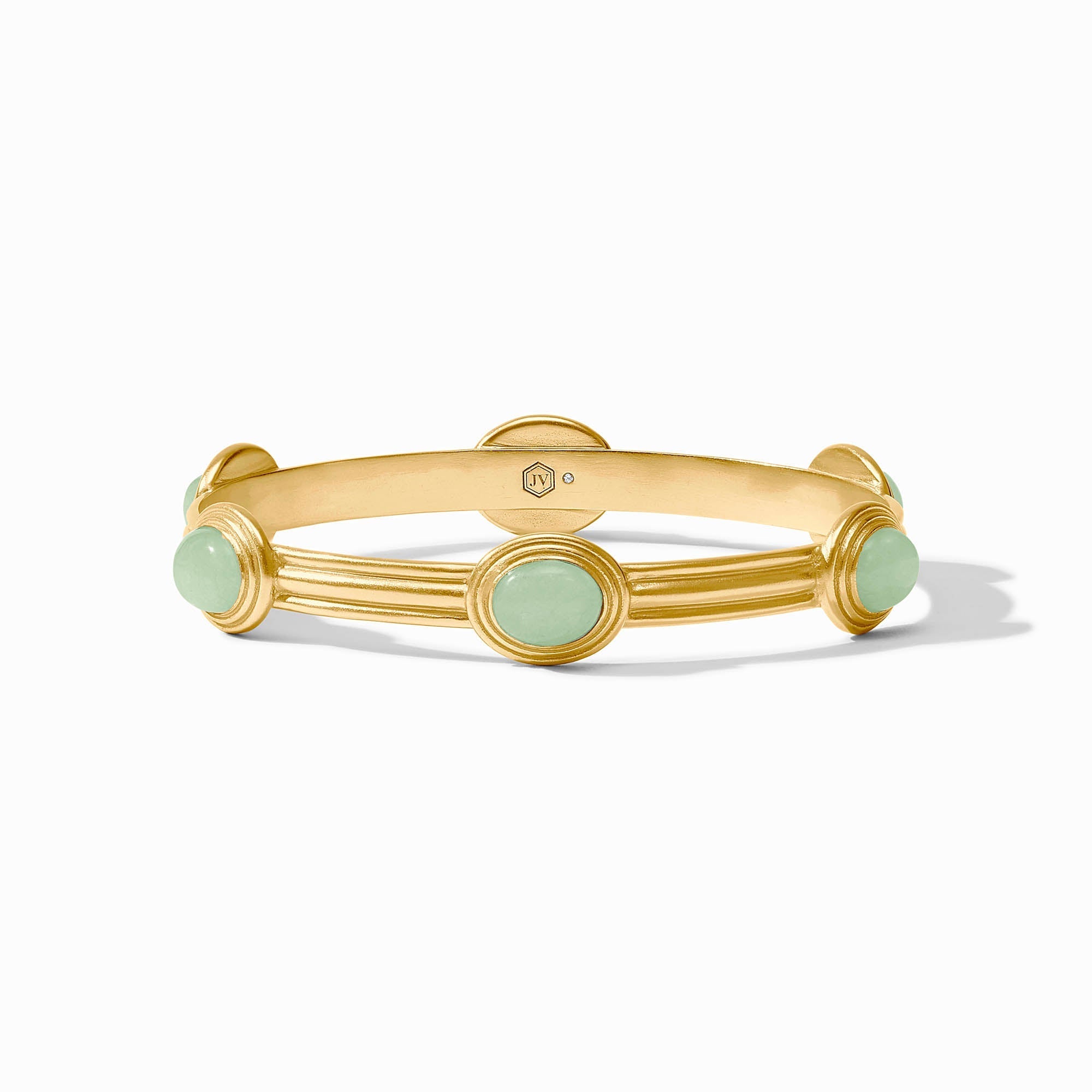 Gold bracelet with green stones on a white background