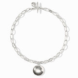 Silver chain bracelet with a round pendant on a white background