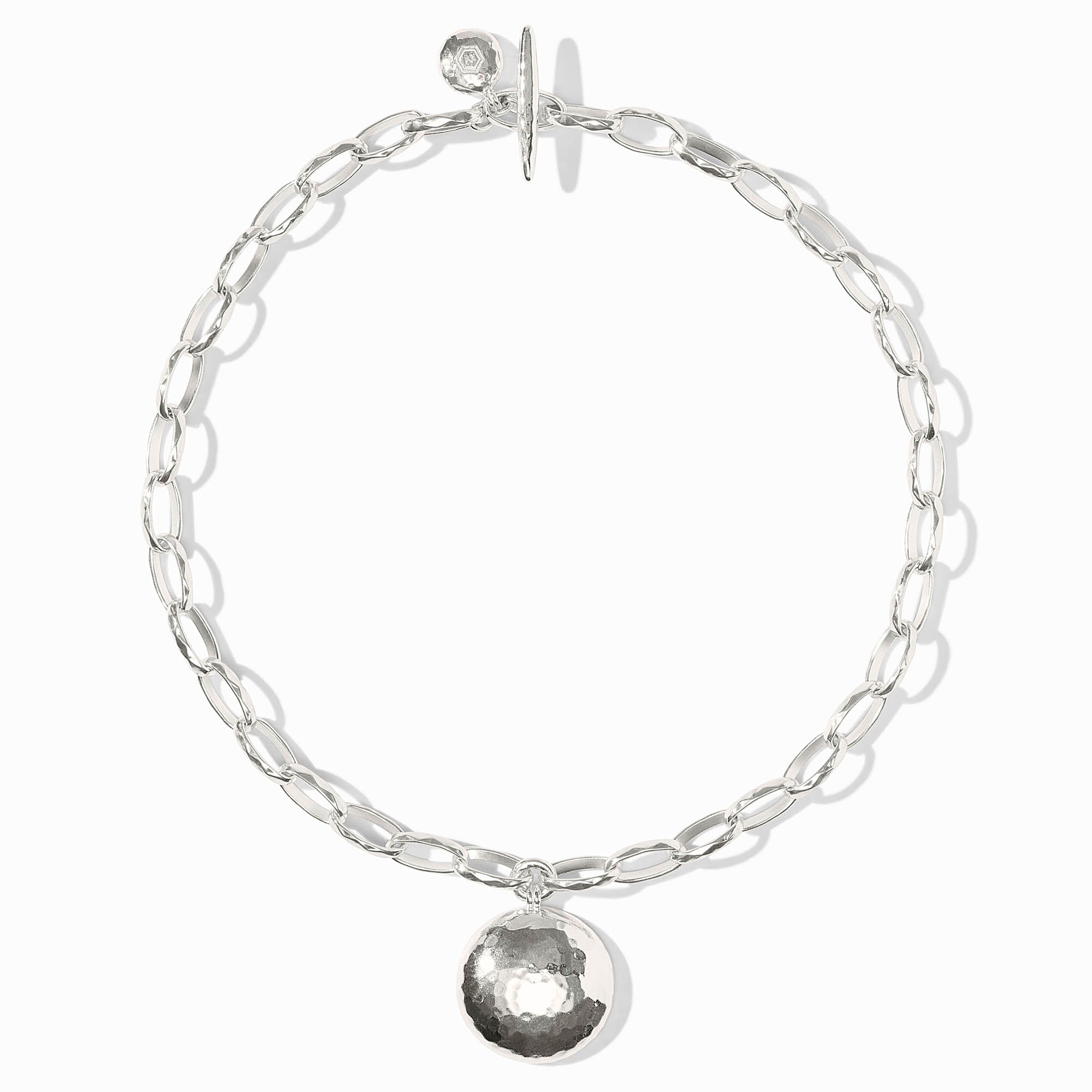 Silver chain bracelet with a round pendant on a white background