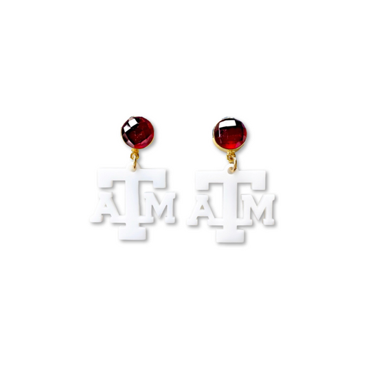 Pair of earrings with 'ATM' logo on a white background
