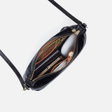 Black leather handbag with gold zipper on a white background