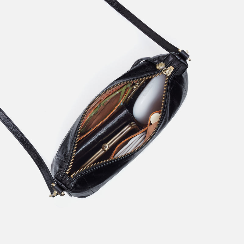 Black leather handbag with gold zipper on a white background