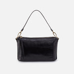 Black leather handbag with gold zipper on a light gray background
