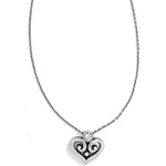 Heart-shaped pendant necklace with intricate design on a white background