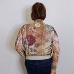 Person wearing a floral-patterned jacket against a plain background