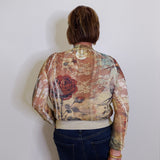 Person wearing a floral-patterned jacket against a plain background