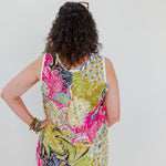 Person wearing a colorful patterned sleeveless top against a white background