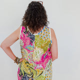 Person wearing a colorful patterned sleeveless top against a white background