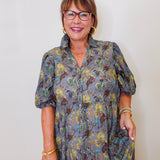 Woman wearing a floral dress with a plain background